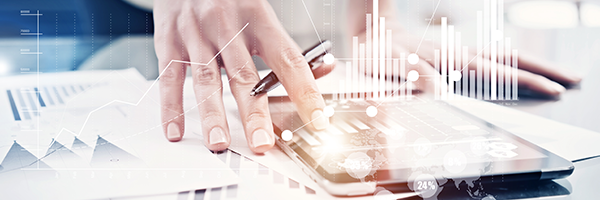 Closeup of a hand holding a pen between its fingers and pressing on an tablet with an image of analytical data superimposed on top.